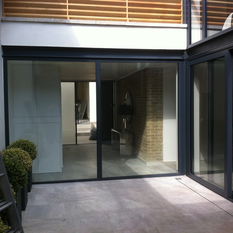 Floor-to-ceiling sliding doors opening to courtyard in Tooting